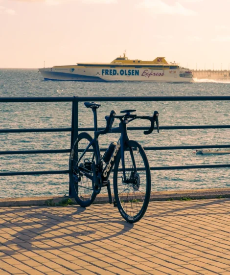 Road Bike Parked on a Railing by the Ocean
