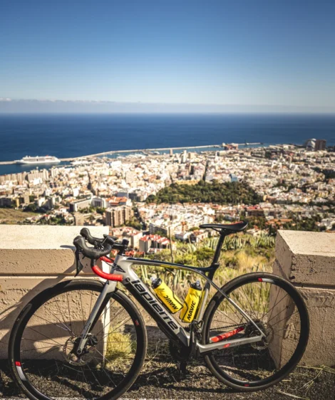 Road Bike Parked on a Ledge Overlooking a City and the Ocean