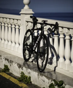 Road Bike Parked on a White Fence by the Ocean
