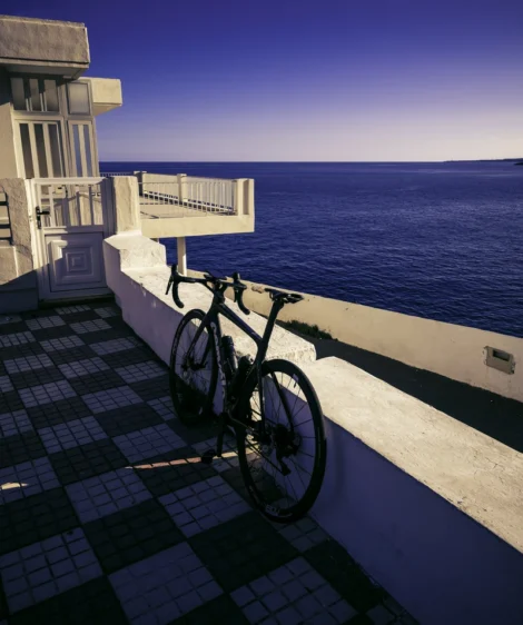 Road Bike Parked on a Brick Walkway by the Ocean