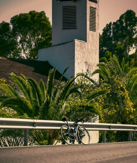 Road Bike Parked on a Railing Near a Church