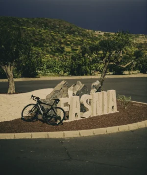 Road Bike Parked Next to a Sign fo Fasnia