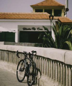Road Bike Parked on a White Fence