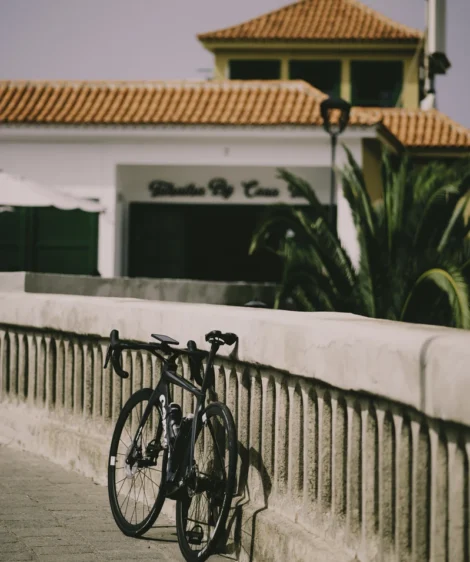 Road Bike Parked on a White Fence