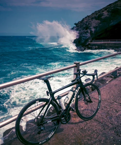 Road Bike Parked on a Railing by the Ocean