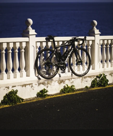 Road Bike Parked on a White Fence by the Ocean