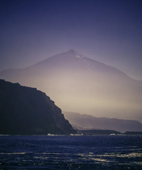 Body of Water With Mountain in the Background
