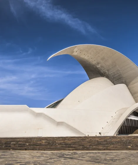 White Building With Curved Roof With Auditorio De Tenerife in the Background