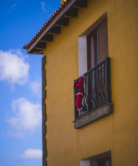 Yellow Building With Red and Blue Flag From the Window