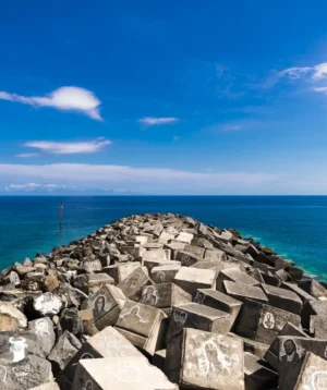 Rocky Beach With Body of Water in the Background