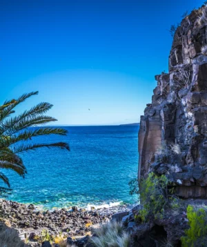 Cliff Side With Body of Water in the Background
