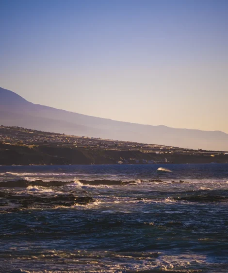 Body of Water With Mountains in the Background