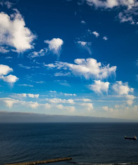 Body of Water With Boats in It and Blue Sky Above