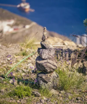 Rocky Cliff With Body of Water in the Background
