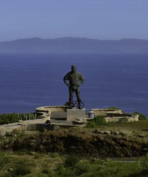 Statue of Man on Rock by the Water
