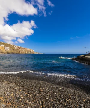 Rocky Beach With Building on the Shore