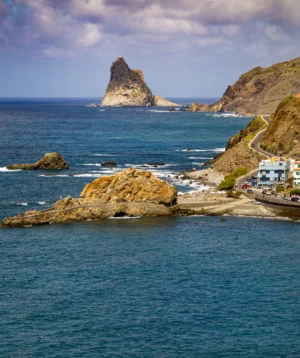 Body of Water With Rocky Island in the Distance With Roques De Anagin the Background