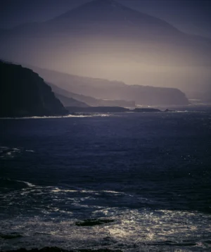 Body of Water With Hills in the Background