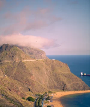 Beach With Hill and Body of Water