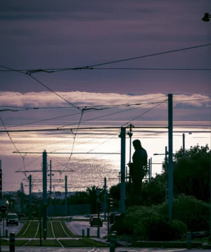 Statue on the Side of Road With Sunset in the Background