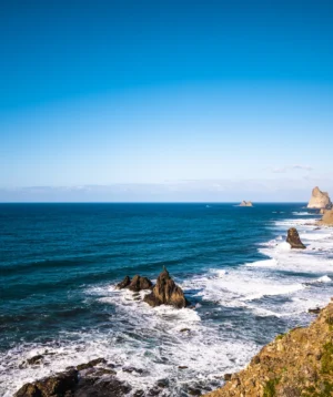 Rocky Beach With Boat in the Distance