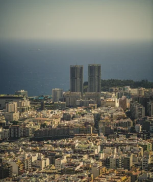City With Tall Buildings and Water in the Background