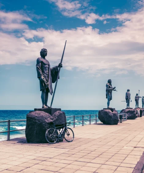 Statue of Person Holding Skateboard