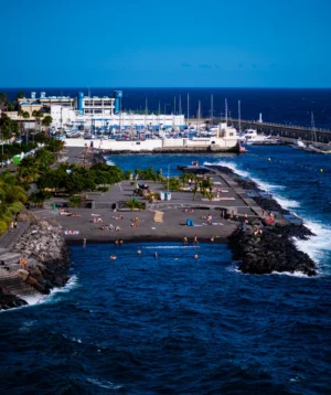 Crowded Beach With Large Cruise Ship in the Background