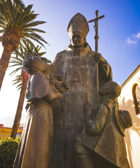 Statue of Man and Woman Holding Baby