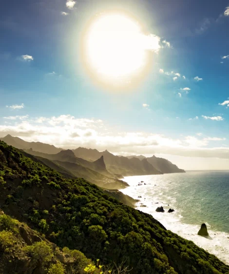 Body of Water With Hills and Trees Around It