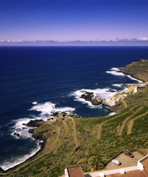 Body of Water With Land and Beach by It