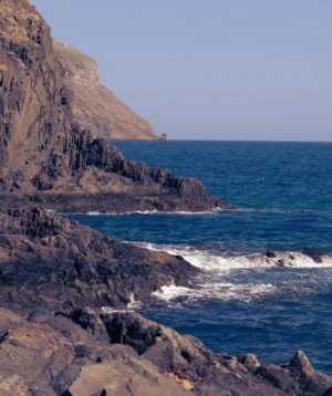 Rocky Beach With Body of Water in the Background
