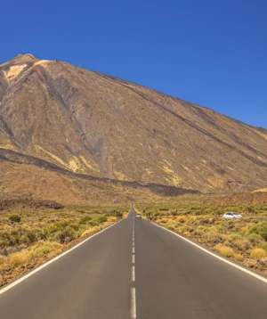 Car Driving on Road in Front of Mountain