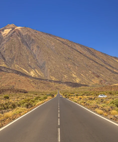 Car Driving on Road in Front of Mountain
