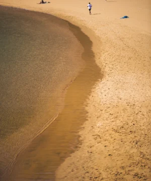 Person Walking on Beach