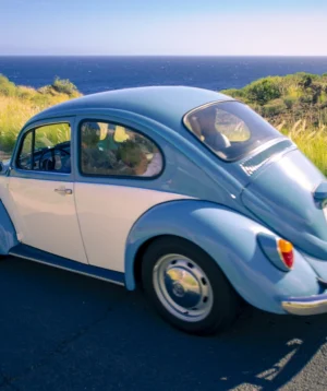 Car Parked on Road Near Body of Water