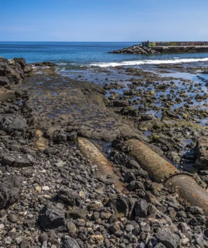 Rocky Beach With Body of Water in the Background