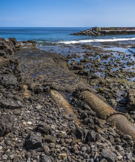 Rocky Beach With Body of Water in the Background