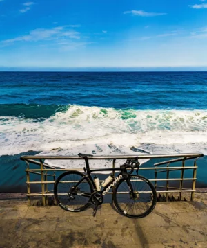 Bicycle Parked on Bench by the Ocean