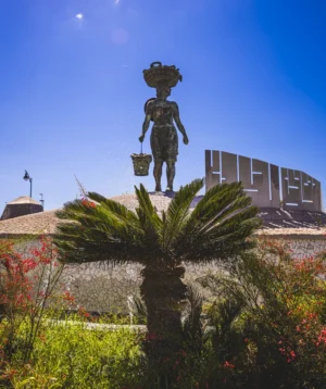Statue of Man Holding Spear in Garden