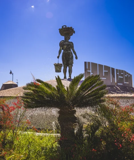 Statue of Man Holding Spear in Garden