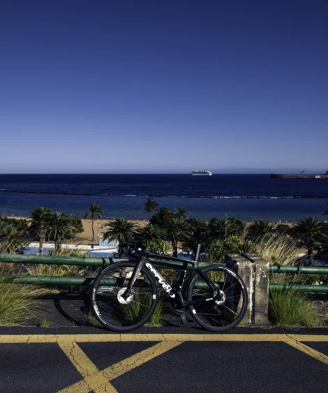 Bicycle Parked on Railing Overlooking Beach